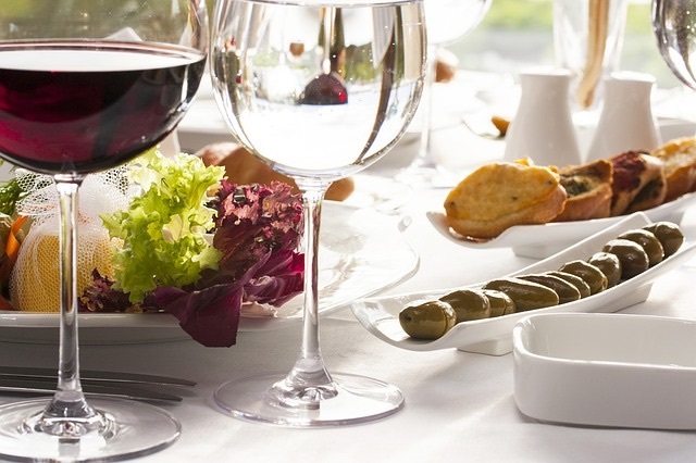 Glass of red wine on a table with food